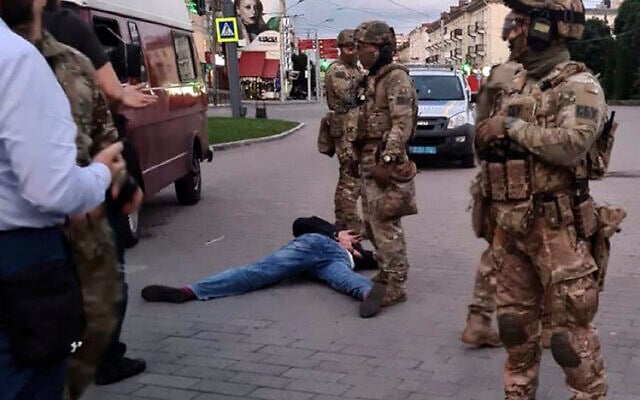 An assailant, who seized a long-distance bus with 10 hostages, lies on the ground after police officers captured him in the city centre of Lutsk, some 400 kilometers (250 miles) west of Kyiv, Ukraine on Tuesday July 21, 2020. The assailant was armed and carrying explosives, according to a Facebook statement by Ukrainian police. (Ukrainian Police Press Office via AP) An assailant, who seized a long-distance bus with 10 hostages, lies on the ground after police officers captured him in the city centre of Lutsk, some 400 kilometers (250 miles) west of Kyiv, Ukraine on Tuesday July 21, 2020. The assailant was armed and carrying explosives, according to a Facebook statement by Ukrainian police. (Ukrainian Police Press Office via AP)