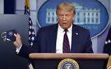 US President Donald Trump holds a face mask as he speaks during a news conference at the White House, Tuesday, July 21, 2020, in Washington. (AP Photo/Evan Vucci)