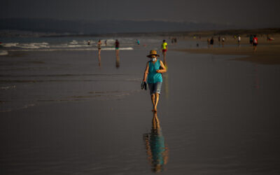 A woman wearing a face mask walks at the beach in Zahara de los Atunes, Cadiz province, south of Spain, on July 25, 2020. (AP Photo/Emilio Morenatti) A woman wearing a face mask walks at the beach in Zahara de los Atunes, Cadiz province, south of Spain, on July 25, 2020. (AP Photo/Emilio Morenatti)