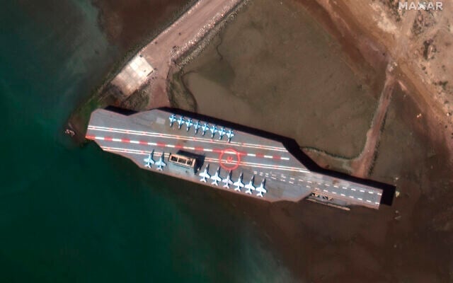In this February 15, 2020, satellite photo provided on July 27, 2020, by Maxar Technologies, a mockup aircraft carrier built by Iran is seen at Bandar Abbas, Iran, before being put to sea. (Maxar Technologies via AP) In this February 15, 2020, satellite photo provided on July 27, 2020, by Maxar Technologies, a mockup aircraft carrier built by Iran is seen at Bandar Abbas, Iran, before being put to sea. (Maxar Technologies via AP)