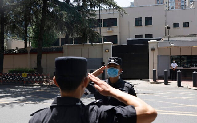 Chinese SWAT officers salute each other at the former United States Consulate in Chengdu in southwest China's Sichuan province on July 27, 2020 (AP Photo/Ng Han Guan) Chinese SWAT officers salute each other at the former United States Consulate in Chengdu in southwest China's Sichuan province on July 27, 2020 (AP Photo/Ng Han Guan)