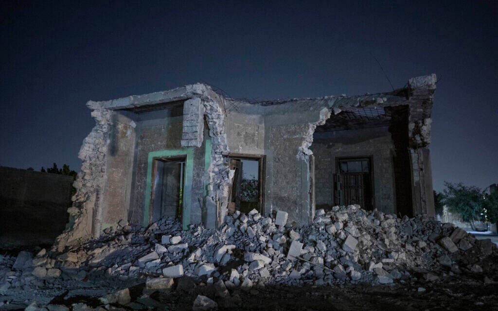 A building stands partially demolished after bulldozers cleared the way for construction of a multilane freeway through the Northern Cemetery, part of the historic City of the Dead, a UNESCO World Heritage Site in Cairo, Egypt, Sunday, July 26, 2020. (AP Photo/Nariman El-Mofty)