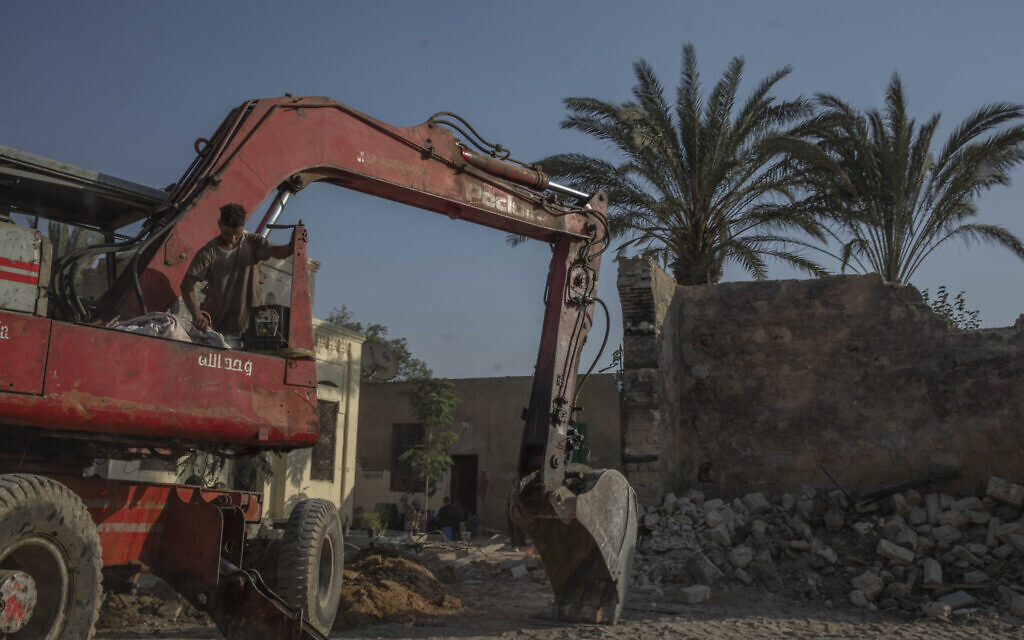 Construction workers knock down walls of family mausoleums to clear way for a new highway running through the historic Northern Cemetery in Cairo, Egypt, Tuesday, July 21, 2020. (AP Photo/Nariman El-Mofty)
