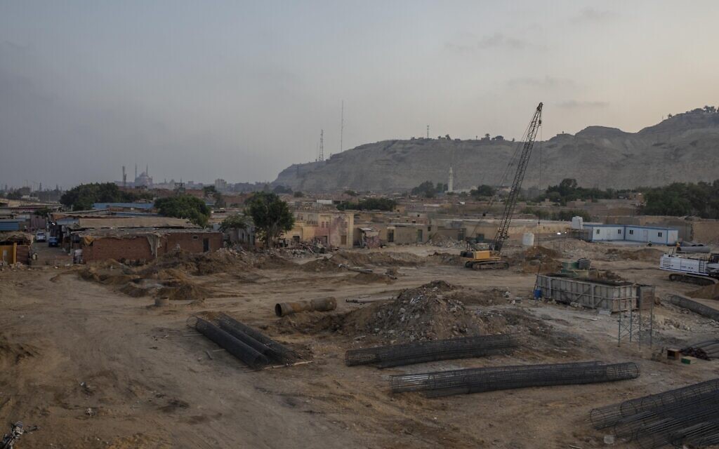 Construction work continues on a highway flyover in a portion cleared of graves in the City of Dead in Cairo, Egypt, with the Citadel, a medieval fortress, visible in the distance Wednesday, July 29, 2020. (AP Photo/Nariman El-Mofty)