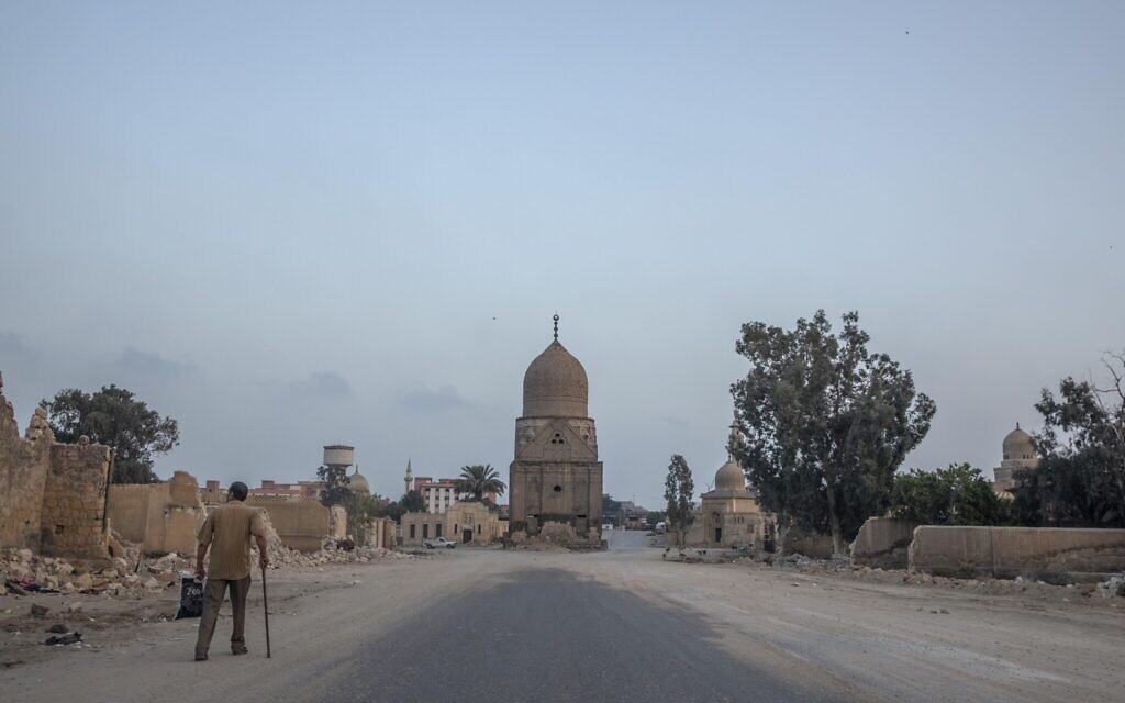 A man looks at graves partially demolished to make way for a new highway through the Northern Cemetery in Cairo, Egypt, Wednesday, July 29, 2020.(AP Photo/Nariman El-Mofty)