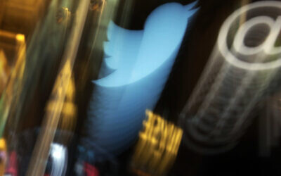 The Twitter logo appears on an updated phone post on the floor of the New York Stock Exchange, November 6, 2013. (AP Photo/Richard Drew, File)
