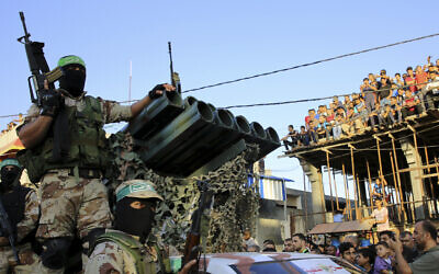 Masked members of Hamas ride a vehicle next to a rocket launcher during a rally in the Rafah refugee camp, Gaza Strip, Aug. 21, 2016 (AP Photo/Adel Hana)