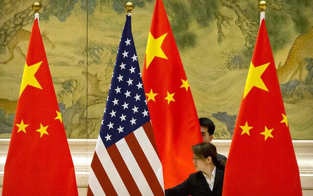 Chinese staffers adjust US and Chinese flags before the opening session of trade negotiations between US and Chinese trade representatives at the Diaoyutai State Guesthouse in Beijing on February 14, 2019. (AP Photo/Mark Schiefelbein, Pool) Chinese staffers adjust US and Chinese flags before the opening session of trade negotiations between US and Chinese trade representatives at the Diaoyutai State Guesthouse in Beijing on February 14, 2019. (AP Photo/Mark Schiefelbein, Pool)