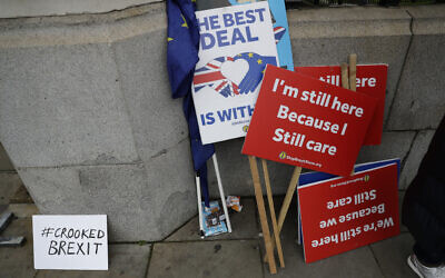 Placards belonging to remain in the European Union, anti-Brexit protesters stand outside the Houses of Parliament in London, January 7, 2020. (Matt Dunham/AP)