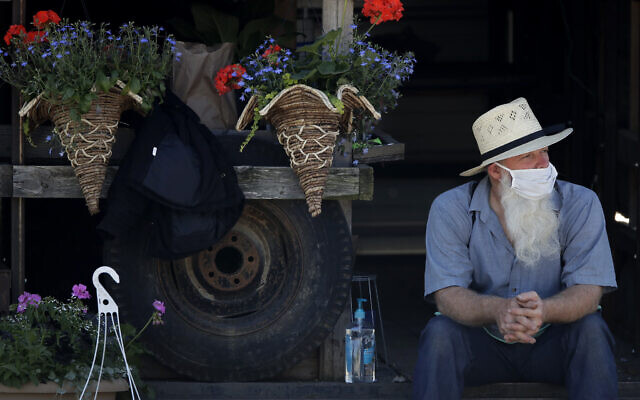 A vendor waits for customers at a drive-thru farmers market, Saturday, May 2, 2020, in Overland Park, Kansas. (AP/Charlie Riedel) A vendor waits for customers at a drive-thru farmers market, Saturday, May 2, 2020, in Overland Park, Kansas. (AP/Charlie Riedel)