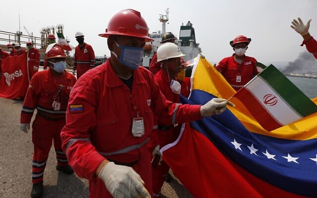 A Venezuelan oil worker holding a small Iranian flag attends a ceremony for the arrival of Iranian oil tanker Fortune at the El Palito refinery near Puerto Cabello, Venezuela on May 25, 2020. (AP Photo/Ernesto Vargas) A Venezuelan oil worker holding a small Iranian flag attends a ceremony for the arrival of Iranian oil tanker Fortune at the El Palito refinery near Puerto Cabello, Venezuela on May 25, 2020. (AP Photo/Ernesto Vargas)
