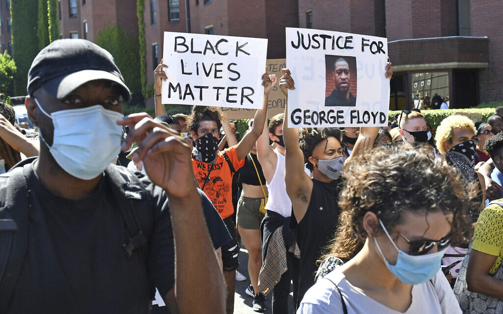 People take part in a Black Lives Matter protest outside the US Embassy in London Sunday, May 31, 2020, to protest against the recent killing of George Floyd by police officers in Minneapolis, Minnesota. (Dominic Lipinski/PA via AP)