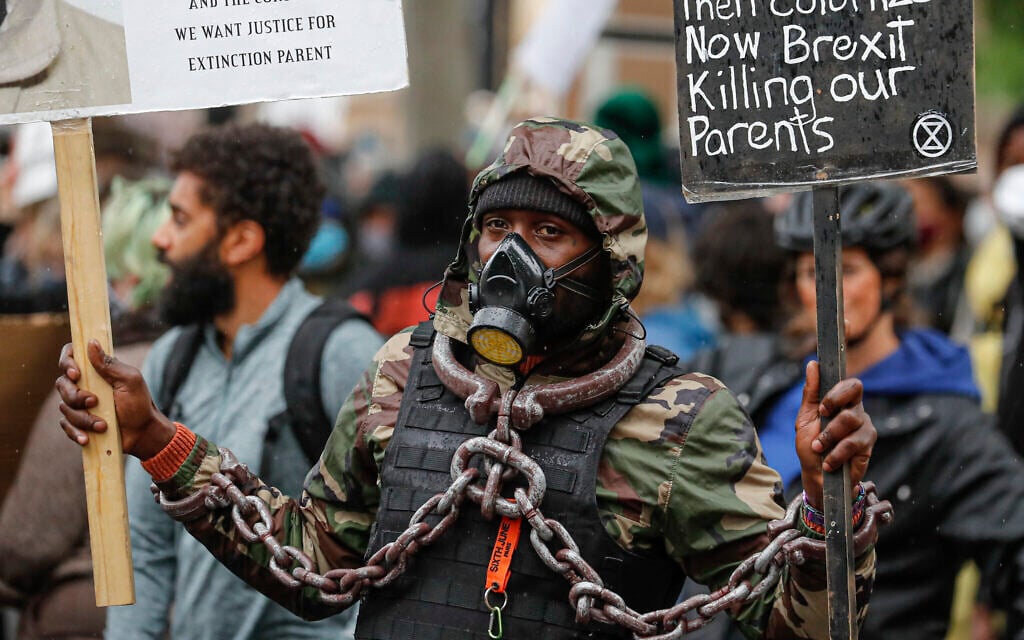 A demonstrator take part in a Black Lives Matter rally in Parliament Square in London, Saturday, June 6, 2020, as people protest against the killing of George Floyd by police officers in Minneapolis, Minnesota. (AP Photo/Frank Augstein)