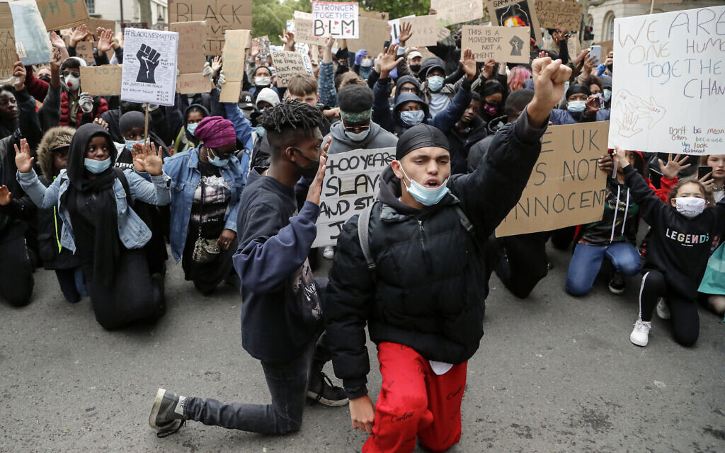 Demonstrators gather at Downing Street during a Black Lives Matter march in London, Saturday, June 6, 2020, as people protest against the killing of George Floyd by police officers in Minneapolis, Minnesota. (AP Photo/Frank Augstein)