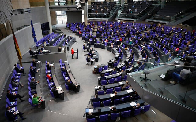 Illustrative: German Chancellor Angela Merkel, center in red, addresses the Bundestag ahead of a EU summit in Berlin, Germany, June 18, 2020. (AP Photo/Markus Schreiber) Illustrative: German Chancellor Angela Merkel, center in red, addresses the Bundestag ahead of a EU summit in Berlin, Germany, June 18, 2020. (AP Photo/Markus Schreiber)