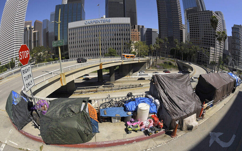 This May 21, 2020 file photo shows a homeless encampment at the corner of Wilshire Boulevard and Beaudry Avenue along the 110 Freeway during the coronavirus outbreak. (AP Photo/Mark J. Terrill, File)