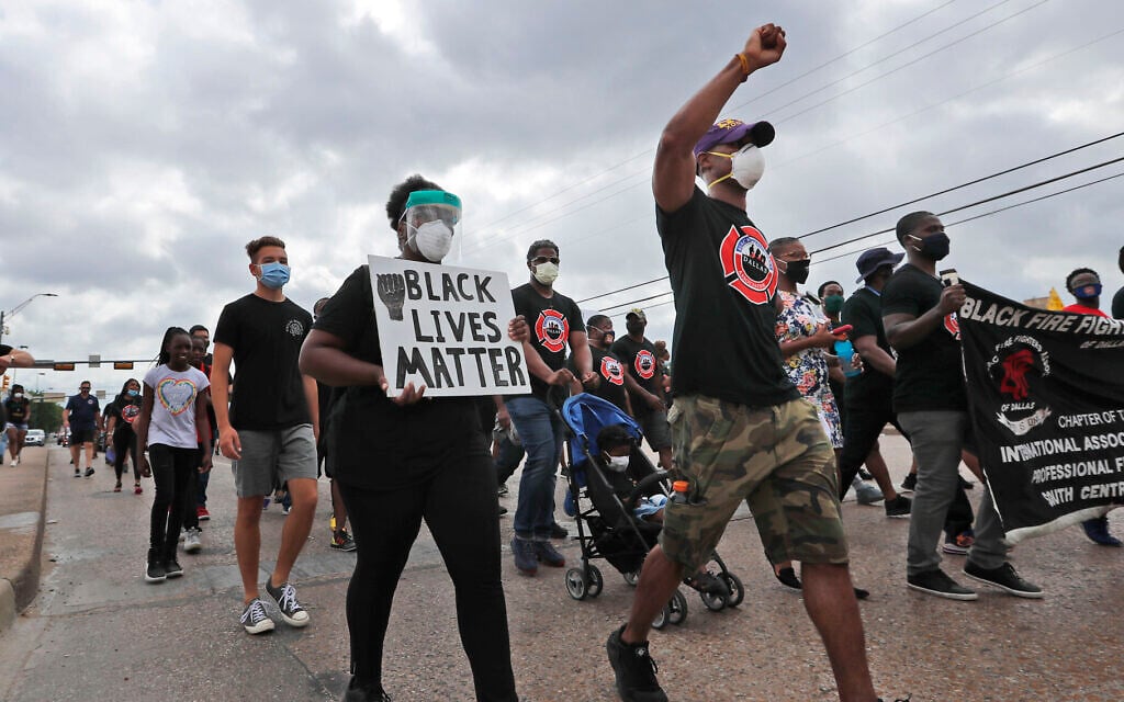 Protesters march in a Black Lives Matter demonstration organized by the Dallas Black Firefighters Association on Juneteenth 2020 in Dallas, June 19, 2020. (AP Photo/LM Otero) Protesters march in a Black Lives Matter demonstration organized by the Dallas Black Firefighters Association on Juneteenth 2020 in Dallas, June 19, 2020. (AP Photo/LM Otero)