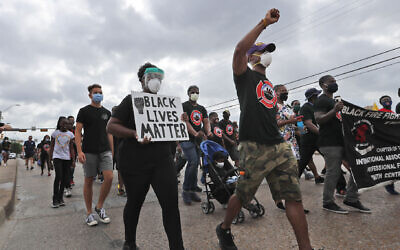 Protesters march in a Black Lives Matter demonstration organized by the Dallas Black Firefighters Association on Juneteenth 2020 in Dallas, June 19, 2020. (AP Photo/LM Otero)