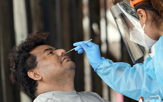 A man is tested at a free coronavirus testing site, provided by United Memorial Medical Center on June 28, 2020, at the Mexican Consulate, in Houston, Texas. (AP Photo/David J. Phillip) A man is tested at a free coronavirus testing site, provided by United Memorial Medical Center on June 28, 2020, at the Mexican Consulate, in Houston, Texas. (AP Photo/David J. Phillip)