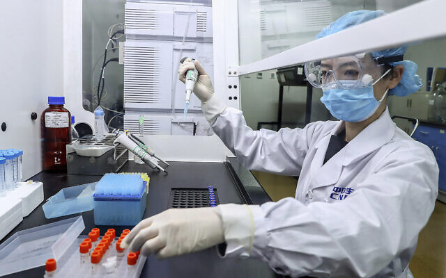 In this April 11, 2020, photo released by Xinhua News Agency, a staff member tests samples of a potential COVID-19 vaccine at a production plant of SinoPharm in Beijing. In the global race to make a coronavirus vaccine, the state-owned Chinese company is boasting that it gave its employees, including top executives, experimental shots even before the government OK'd testing in people. (Zhang Yuwei/Xinhua via AP) In this April 11, 2020, photo released by Xinhua News Agency, a staff member tests samples of a potential COVID-19 vaccine at a production plant of SinoPharm in Beijing. In the global race to make a coronavirus vaccine, the state-owned Chinese company is boasting that it gave its employees, including top executives, experimental shots even before the government OK'd testing in people. (Zhang Yuwei/Xinhua via AP)