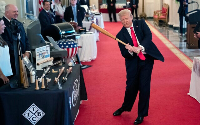 US President Donald Trump swings a baseball bat during the Spirit of America Showcase at the White House, July 2, 2020, in Washington. (AP Photo/Evan Vucci) US President Donald Trump swings a baseball bat during the Spirit of America Showcase at the White House, July 2, 2020, in Washington. (AP Photo/Evan Vucci)