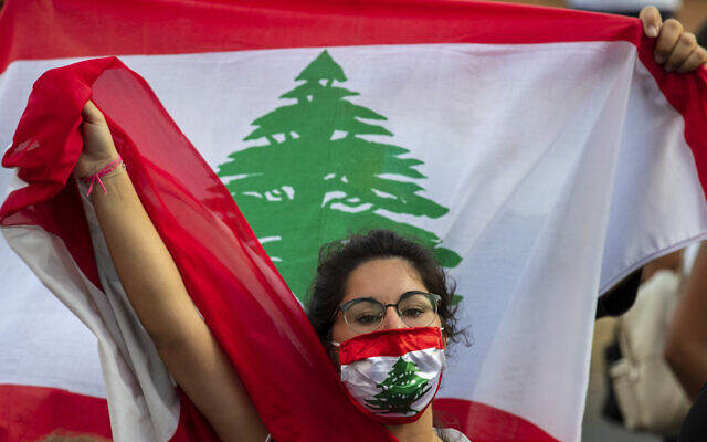 An anti-government protester shouts slogans while wearing a mask with the colors of the Lebanese flag in Beirut, Lebanon, on July 2, 2020. (Hassan Ammar/AP) An anti-government protester shouts slogans while wearing a mask with the colors of the Lebanese flag in Beirut, Lebanon, on July 2, 2020. (Hassan Ammar/AP)