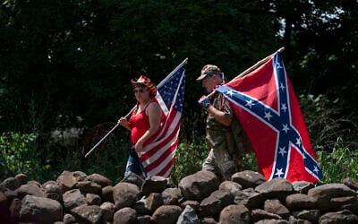TIlustrative: People carry an American flag and a Confederate flag as they walk on a pathway at the Gettysburg National Military Park, Saturday, July 4, 2020, in Gettysburg, Pa. (AP Photo/Carolyn Kaster)
