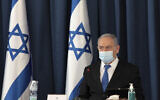 Prime Minister Benjamin Netanyahu wears a face mask to help prevent the spread of the coronavirus as he opens the weekly cabinet meeting, at the foreign ministry, in Jerusalem, July 5, 2020. (Gali Tibbon/AP)