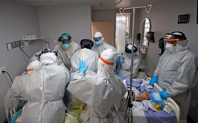 Medical personnel struggle, in vain, to save the life of a patient in the coronavirus unit at United Memorial Medical Center in Houston, Texas, July 6, 2020. (AP Photo/David J. Phillip) Medical personnel struggle, in vain, to save the life of a patient in the coronavirus unit at United Memorial Medical Center in Houston, Texas, July 6, 2020. (AP Photo/David J. Phillip)