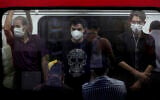 People wearing protective face masks to help prevent the spread of the coronavirus stand inside a train in Tehran, Iran, July 8, 2020. (AP Photo/Ebrahim Noroozi)