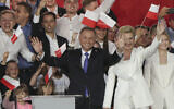 Incumbent President Andrzej Duda, left, and his wife Agata Kornhauser-Duda wave to supporters in Pultusk, Poland, July 12, 2020 (AP Photo/Czarek Sokolowski)