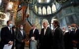 Turkey's President Recep Tayyip Erdogan, center, and other officials visit the Byzantine-era Hagia Sophia, one of Istanbul's main tourist attractions in the historic Sultanahmet district of Istanbul, July 19, 2020, days after he formally reconverted Hagia Sophia into a mosque and declared it open for Muslim worship, after a high court annulled a 1934 decision that had made the religious landmark a museum.(Turkish Presidency via AP, Pool)