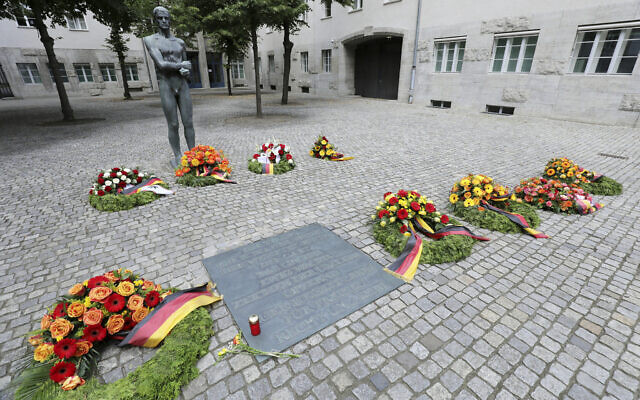 Numerous wreaths and flower arrangements have been laid in the Bendlerblock at the German Resistance Memorial Center on the spot where Claus Graf Schenk von Stauffenberg and other officers were shot in 1944 after the failed assassination attempt on Adolf Hitler, in Berlin, Germany, Monday, July 20, 2020. (Wolfgang Kumm/dpa via AP)