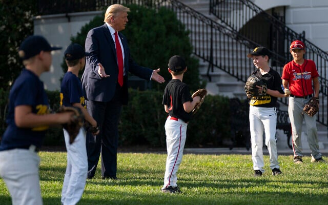 US President Donald Trump greets youth baseball players on the South Lawn of the White House to mark Opening Day for Major League Baseball, Thursday, July 23, 2020, in Washington. (AP/Evan Vucci) US President Donald Trump greets youth baseball players on the South Lawn of the White House to mark Opening Day for Major League Baseball, Thursday, July 23, 2020, in Washington. (AP/Evan Vucci)