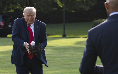 US President Donald Trump plays catch with former New York Yankees Hall of Fame pitcher Mariano Rivera as he greets youth baseball players on the South Lawn of the White House to mark Opening Day for Major League Baseball, July 23, 2020, in Washington. (AP Photo/Evan Vucci)