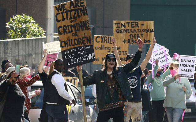Demonstrators working in the hospitality industry protest against lockdown regulations in the streets close to Parliament in Cape Town, South Africa, Friday July 24, 2020. (AP/Nardus Engelbrecht) Demonstrators working in the hospitality industry protest against lockdown regulations in the streets close to Parliament in Cape Town, South Africa, Friday July 24, 2020. (AP/Nardus Engelbrecht)