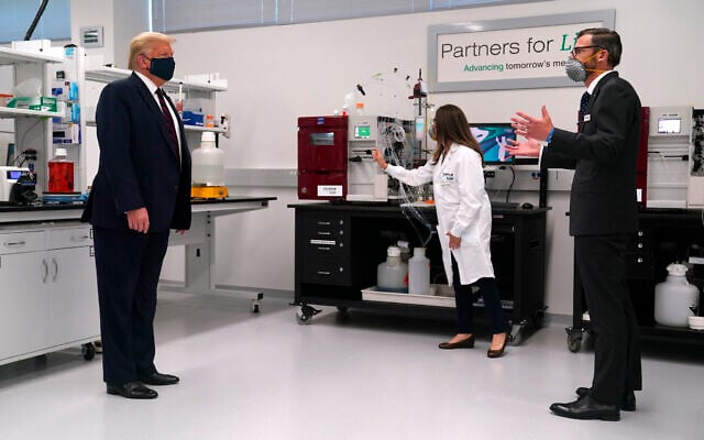 Fujifilm Diosynth Biotechnologies CEO Martin Meeson, right, speaks as President Donald Trump wears a face mask as he participates in a tour of Bioprocess Innovation Center at Fujifilm Diosynth Biotechnologies, Monday, July 27, 2020, in Morrisville, N.C. (AP Photo/Evan Vucci) Fujifilm Diosynth Biotechnologies CEO Martin Meeson, right, speaks as President Donald Trump wears a face mask as he participates in a tour of Bioprocess Innovation Center at Fujifilm Diosynth Biotechnologies, Monday, July 27, 2020, in Morrisville, N.C. (AP Photo/Evan Vucci)