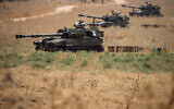 Israeli mobile artillery units sit in place in northern Israel near the border with Lebanon, July 28, 2020. (AP Photo/Ariel Schalit)
