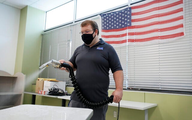 Chief custodian Ryan Nail cleans a desk in a classroom at the Jesse Franklin Taylor Education Center, July 29, 2020, in Des Moines, Iowa. (AP Photo/Charlie Neibergall) Chief custodian Ryan Nail cleans a desk in a classroom at the Jesse Franklin Taylor Education Center, July 29, 2020, in Des Moines, Iowa. (AP Photo/Charlie Neibergall)
