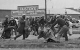 State troopers swing billy clubs to break up a civil rights voting march in Selma, Alabama March 7, 1965.  John Lewis, chairman of the Student Nonviolent Coordinating Committee (in the foreground) is being beaten by a state trooper. (AP Photo)
