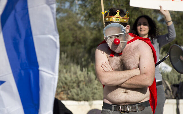 An activist wears a mask bearing a portrait of Prime Minister Benjamin Netanyahu on March 27, 2016. (AP/Ariel Schalit) An activist wears a mask bearing a portrait of Prime Minister Benjamin Netanyahu on March 27, 2016. (AP/Ariel Schalit)