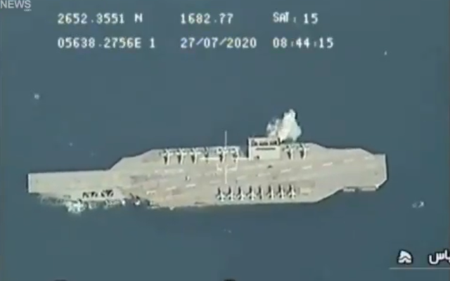 In video released on July 28, 2020, an explosion is seen next to a mock US aircraft carrier in the Strait of Hormuz during military exercises held by Iran's Islamic Revolutionary Guard Corps. (Screen capture/Twitter) In video released on July 28, 2020, an explosion is seen next to a mock US aircraft carrier in the Strait of Hormuz during military exercises held by Iran's Islamic Revolutionary Guard Corps. (Screen capture/Twitter)