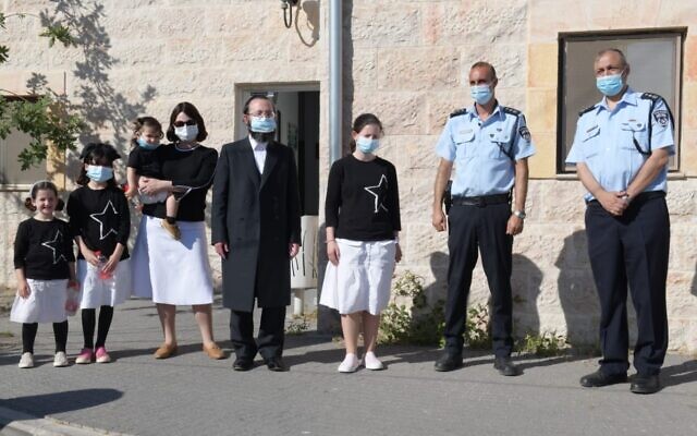 Batya Getter, center, along with her family as they meet with senior Jerusalem police officers, July 13, 2020. (Israel Police) Batya Getter, center, along with her family as they meet with senior Jerusalem police officers, July 13, 2020. (Israel Police)