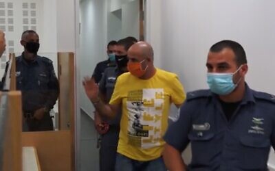 Screen capture from video of David Chaim, center, arrives at the Central District Court for the verdict in his trial for the murder of his ex-wife, Ofira, July 12, 2020. (Ynet)