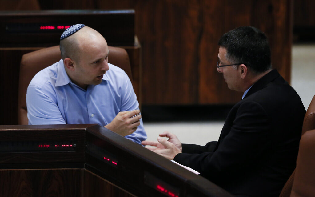 Then-MKs Gideon Sa'ar, right, and Naftali Bennett in the Knesset plenum on February 24, 2014. (Miriam Alster/Flash90) Then-MKs Gideon Sa'ar, right, and Naftali Bennett in the Knesset plenum on February 24, 2014. (Miriam Alster/Flash90)