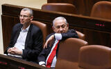 Prime Minister Benjamin Netanyahu, right, with then-tourism minister Yariv Levin during a vote at the assembly hall of the Knesset on February 13, 2018. (Yonatan Sindel/Flash90/File)