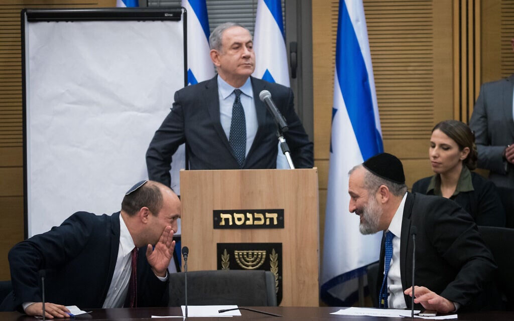 Prime Minister Benjamin Netanyahu speaks as then-defense minister Naftali Bennett and Interior Minister Aryeh Deri confer, during a meeting of right-wing party leaders at the Knesset following election day, on March 4, 2020. (Yonatan Sindel/Flash90) Prime Minister Benjamin Netanyahu speaks as then-defense minister Naftali Bennett and Interior Minister Aryeh Deri confer, during a meeting of right-wing party leaders at the Knesset following election day, on March 4, 2020. (Yonatan Sindel/Flash90)