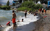 Illustrative -- people enjoy the beaches at the Sea of Galilee, June 19, 2020 (David Cohen/Flash90)