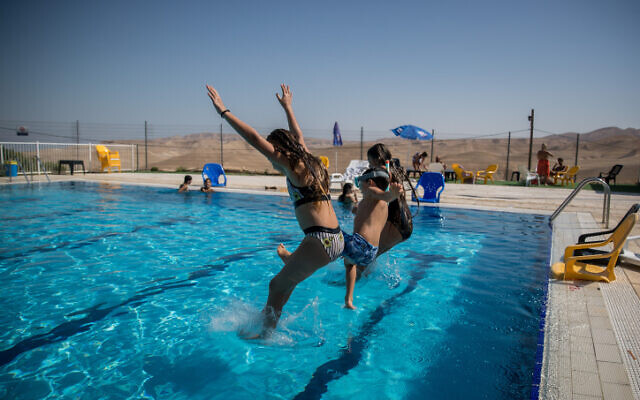 Illustrative photo of youth jumping into a pool. (Yonatan Sindel/Flash90)