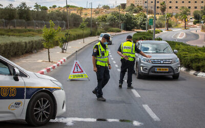 Police put up roadblocks at the ultra-Orthodox city of Beitar Illit outside of Jerusalem, which was declared a restricted zone due to a high rate of coronavirus infections, July 9, 2020. (Nati Shohat/Flash90)